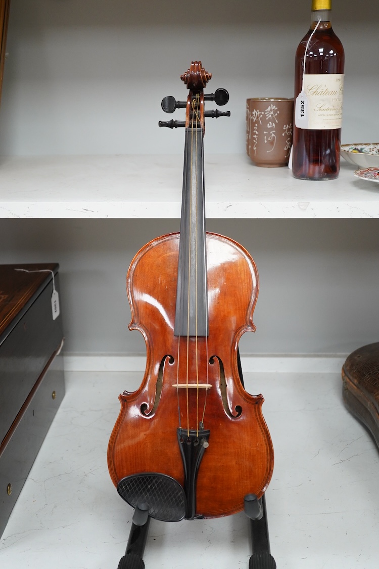 A late 19th century German violin after Pablo Maggini in bird’s eye maple with a fully mounted German bow in a crocodile skin case with retailers ivorine label reading; ‘Edward Withers, 22 Wardour Street, phone City 1899